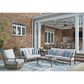 Ashley Rainier Ranch Outdoor Sofa with Beige Cushion in Brown, , large