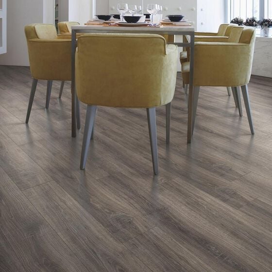 dining room with dining table with yellow chairs and a woodgrain laminate floor