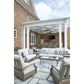 Ashley Rainier Ranch Outdoor Loveseat with Beige Cushion in Brown, , large