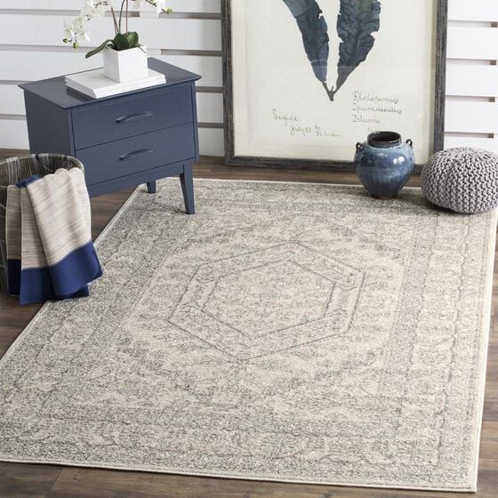 area rug on a room floor with blue end table art and a vase