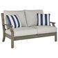 Ashley Rainier Ranch Outdoor Loveseat with Beige Cushion in Brown, , large