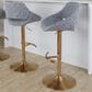 LumiSource Fabrico Swivel Adjustable Bar Stool with Grey Noise Fabric Upholstery and Rounded T Footrest in Gold (Set of 2), , large