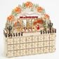 The Gerson Company Lighted Laser Cut Wood Holiday Village Scene Advent Calendar in Tan, , large