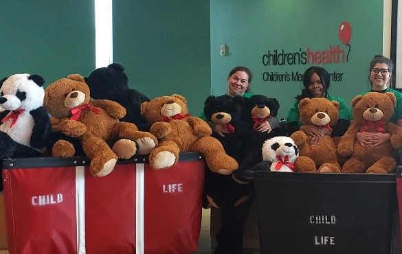 Group surrounded around donated teddy bears