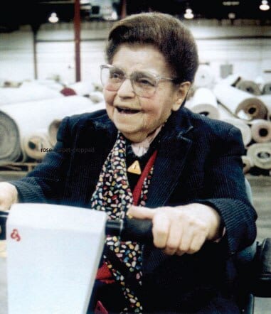Rose Blumkin on a motor scooter in the carpet warehouse