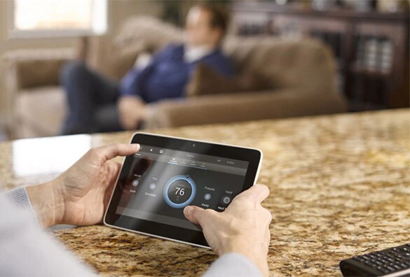 Person using tablet to view Smart Home System