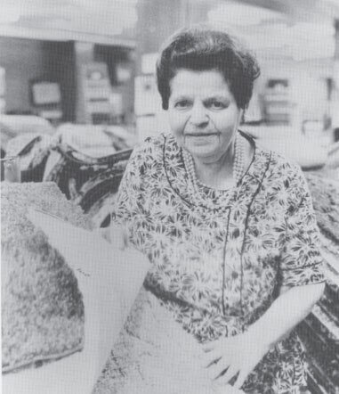 Rose Blumkin on a motor scooter in the carpet warehouse