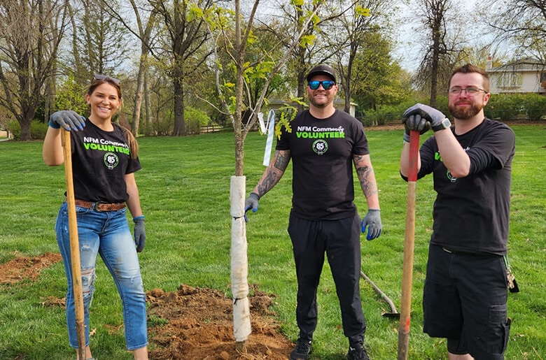 NFM employees volunteering together to help clean up trash and recycle