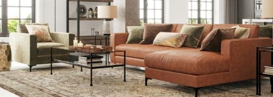 Living room with dark orange leather sofa and warm neutral decor & accents