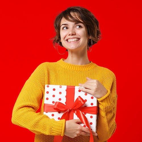 Woman in yellow sweater on red background