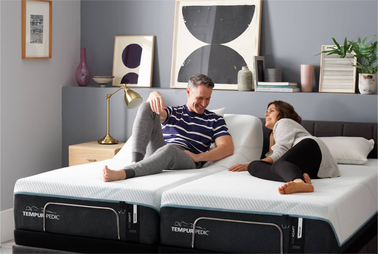 Couple relaxing on Tempur-Pedic bed with adjustable base.