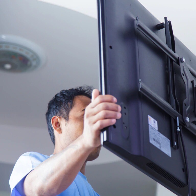 TV being mounted in home